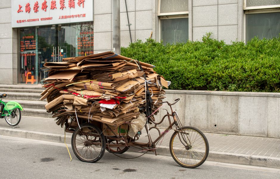 A tricycle loaded with cardboard boxes for recycling on a street in Shanghai, China.